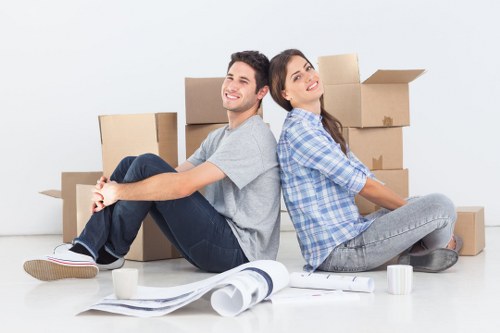Local movers handling furniture in a West Ealing street
