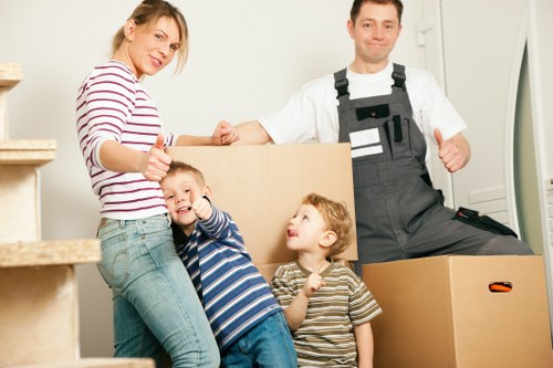 Trained van crew handling boxes and furniture with proper lifting technique